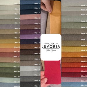 May include: A fabric swatch sample board featuring two columns labeled Milpa 1 through 35 and Ibiza 1 through 16, displaying a wide variety of solid colors and textures. A central white logo reads CUSHION ART LUVORIA Timeless Elegance.