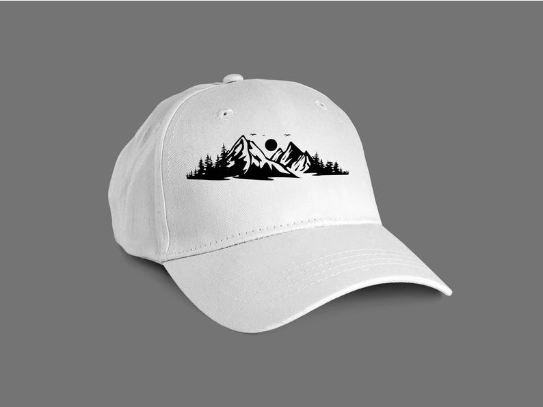 May include: White baseball cap with a black silhouette of mountains, a sun, and trees.