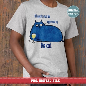 May include: A light gray t-shirt featuring a blue cartoon cat holding a glass of wine. The text on the shirt reads "All guests must be approved by the cat." A digital design graphic is in the upper right corner.