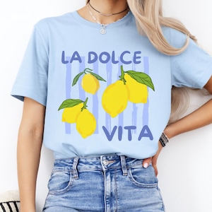 a woman wearing a blue t - shirt with lemons on it