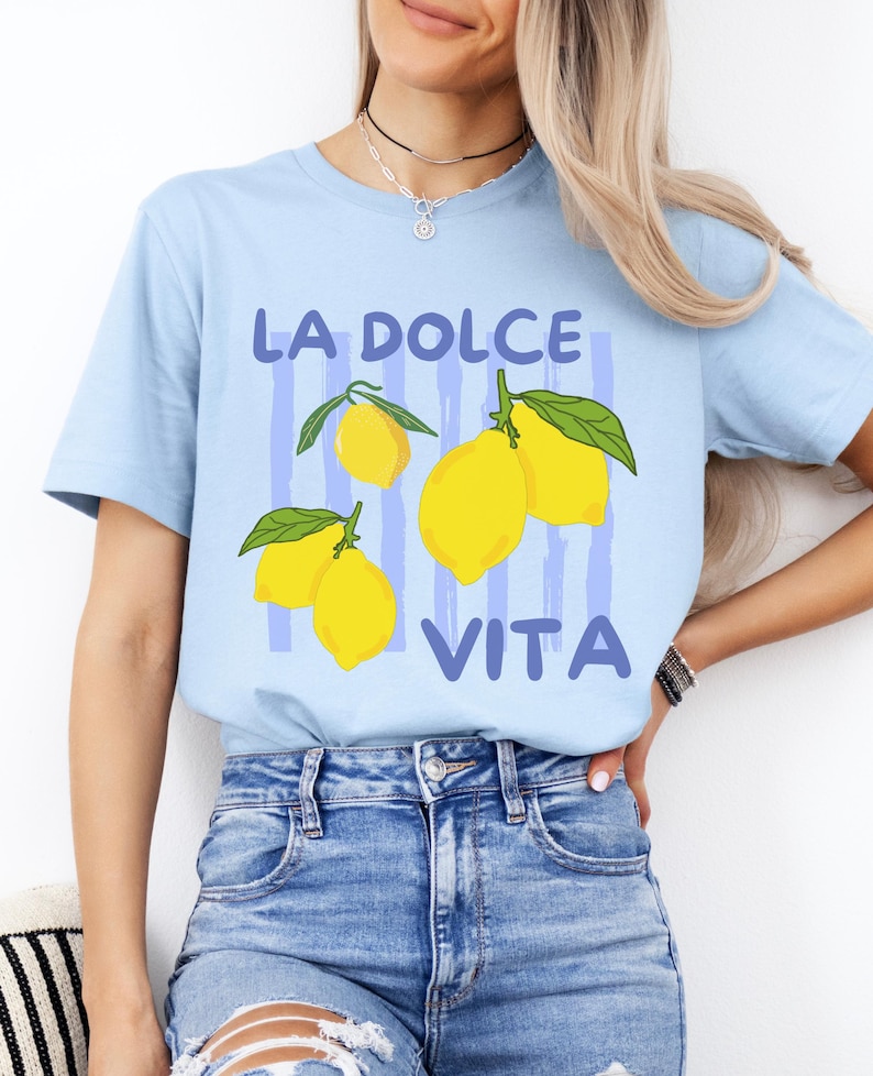 a woman wearing a blue t - shirt with lemons on it