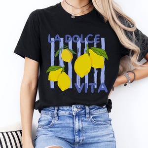 a woman wearing a black t - shirt with lemons on it