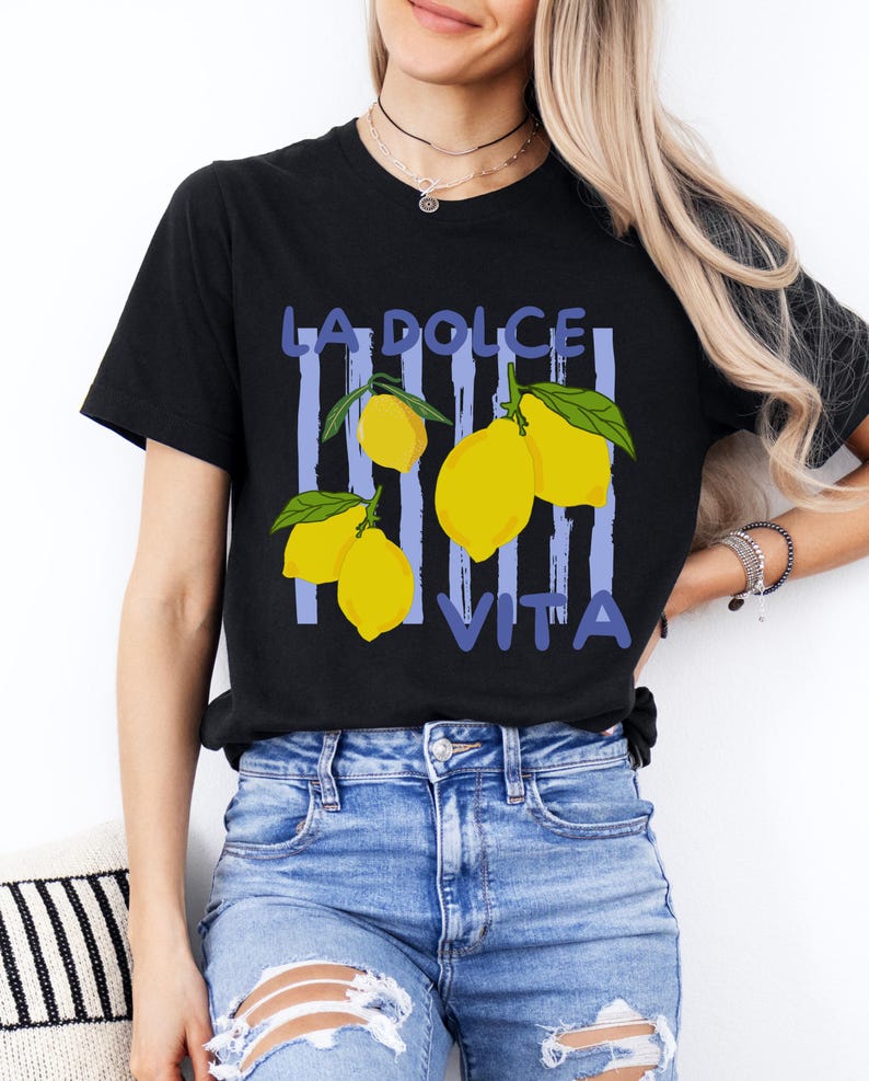 a woman wearing a black t - shirt with lemons on it