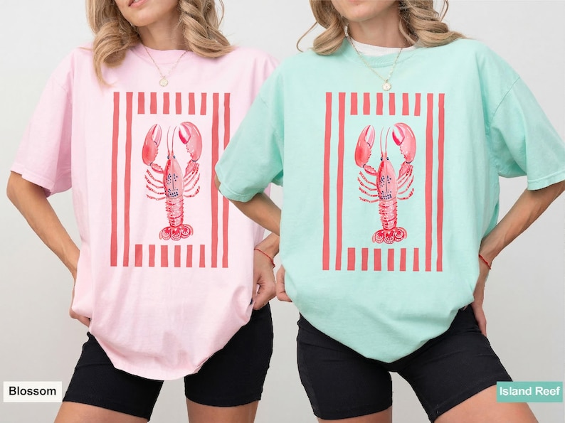 Pink and mint t-shirts with lobster and stripes graphic.