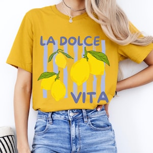 a woman wearing a yellow shirt with lemons on it