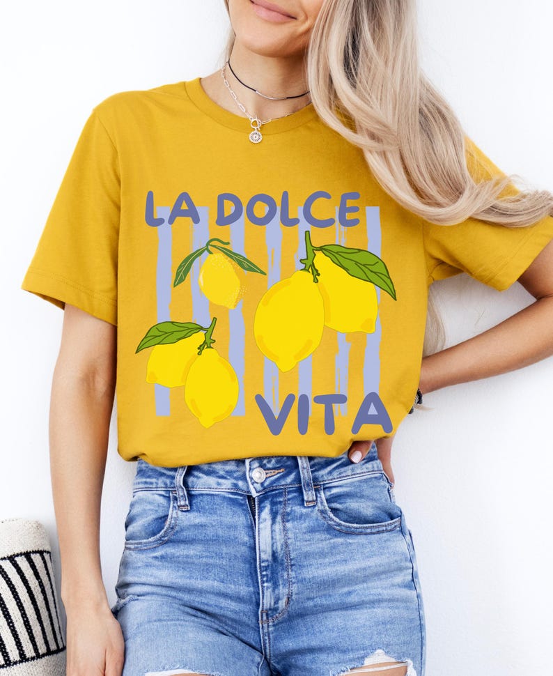 a woman wearing a yellow shirt with lemons on it