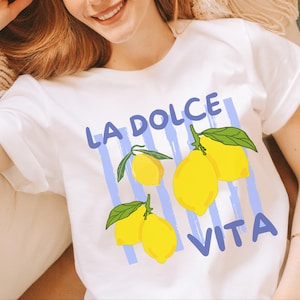 a woman wearing a t - shirt with lemons on it