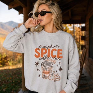 Light gray sweatshirt with "Pumpkin Spice Coffee Club" autumn graphic.