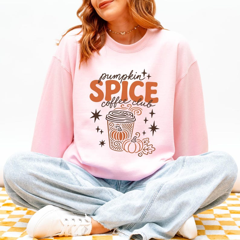 Pink sweatshirt with "Pumpkin Spice Coffee Club" graphic and coffee cup.