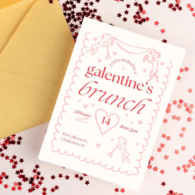 May include: A white card with pink lettering and illustrations of cherubs. The card reads "You're invited to a Galentine's Brunch" with the date "February 14" and the time "11am-2pm". The address is listed as "834 Calhoun St., Charleston, SC".