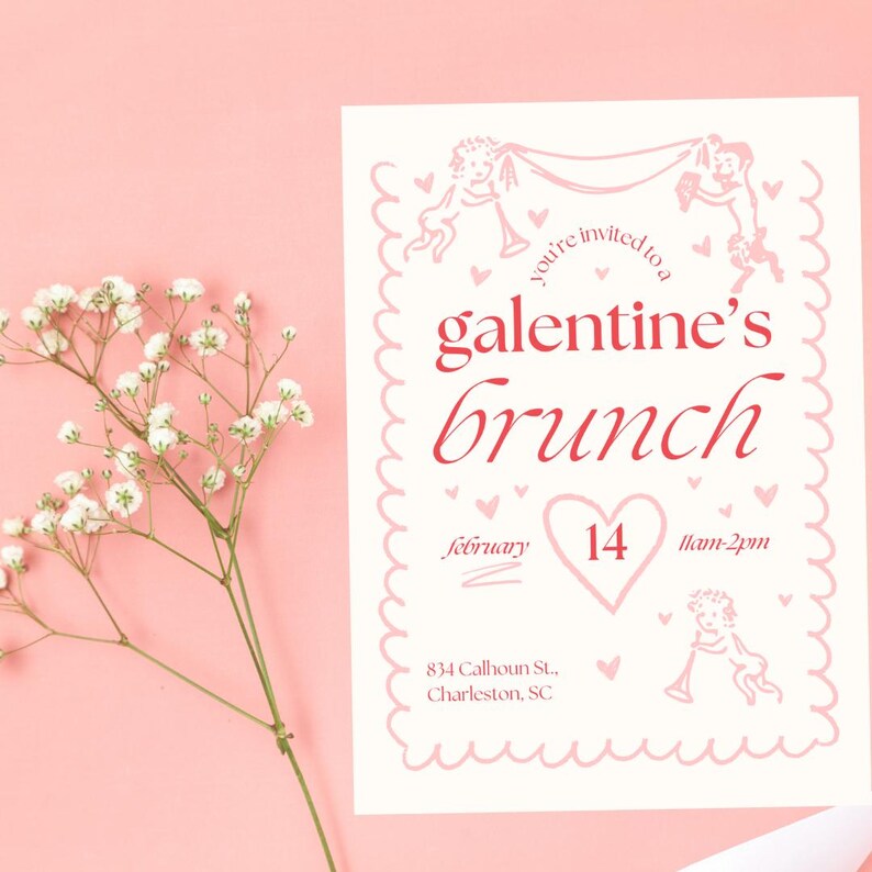 May include: A pink and white invitation card with a pink border and a heart-shaped design. The text on the card reads "You're invited to a Galentine's Brunch" with the date "February 14" and the time "11am-2pm". The address is "834 Calhoun St., Charleston, SC".
