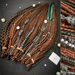 May include: A bundle of brown and green synthetic dreadlocks with beads and other embellishments. The dreadlocks are tied together with rubber bands.