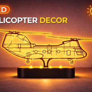 May include: An LED helicopter decor piece. The illuminated design features a detailed outline of a helicopter, with the text "LED HELICOPTER DECOR" above it. The base is a black rectangle with small lights.