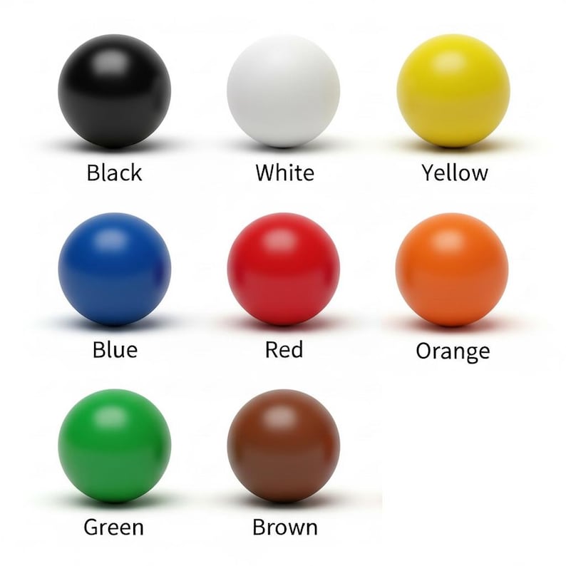 Puede incluir: Nueve esferas de colores variados: negro, blanco, amarillo, azul, rojo, naranja, verde y marr&oacute;n. Cada esfera tiene un acabado liso y mate. Los nombres de los colores est&aacute;n impresos debajo en fuente sans-serif.