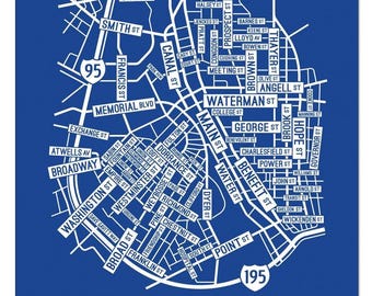 May include: A blue map print of Providence featuring white street names and highway markers for 95 and 195. The design displays a detailed grid of city roads with the word PROVIDENCE printed in large white capital letters at the bottom.
