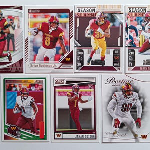 May include: Seven football trading cards featuring players in burgundy and gold. The cards show action shots of players, with names and team logos. Some cards include the text "SEASON TICKET". Measurements are not applicable.