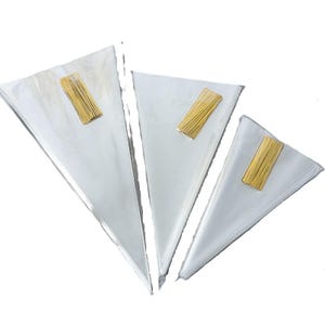 May include: Three clear, cone-shaped cellophane bags with gold-coloured rectangular closures. The bags are arranged in a fan shape, with the largest at the back and the smallest at the front. The bags are empty.