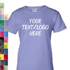 May include: A light blue t-shirt with the text "YOUR TEXT/LOGO HERE" printed in white on the front.