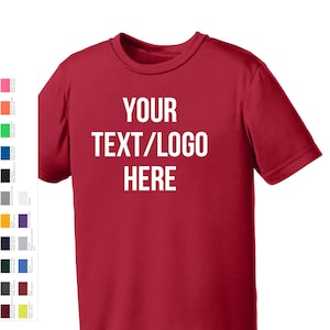 May include: Red short-sleeved t-shirt with the text "YOUR TEXT/LOGO HERE" printed in white on the front.
