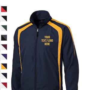 May include: A navy blue jacket with yellow accents. The jacket has a zipper closure and a stand-up collar. The text "YOUR TEXT/LOGO HERE" is embroidered on the front of the jacket.