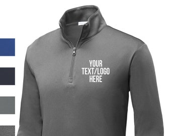 May include: A gray long-sleeve performance shirt with a quarter-zip closure. The shirt has a white embroidered design that says "YOUR TEXT/LOGO HERE".