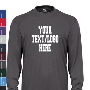 May include: A charcoal gray long-sleeve shirt with a white crew neck. The shirt has the text "YOUR TEXT/LOGO HERE" printed on the front in a white block font.