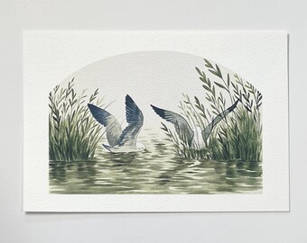 May include: A watercolour painting on textured paper depicting two birds with grey and white plumage wading in water among green reeds. The scene is framed within an arched shape, showing the birds with wings partially raised in the water.