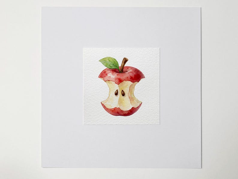 May include: Watercolor painting of a partially eaten red apple. The apple core is visible, with two seeds remaining. A green leaf and brown stem are attached to the top. The artwork is on a textured white paper.