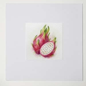 May include: Watercolor painting of two dragon fruits, one whole and one sliced open. The fruits are a vibrant pink with green accents and white flesh dotted with black seeds. The artwork is on textured paper.