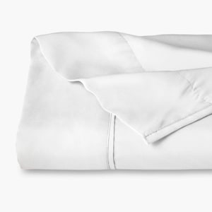 May include: A crisp white bed sheet featuring a smooth, solid-colored surface with a clean, folded top edge. The fabric displays a subtle, straight-stitched hem detail running horizontally across the upper portion of the textile, creating a simple, uniform appearance throughout the folded material.