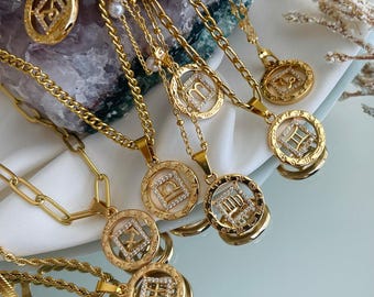 May include: A collection of gold necklaces with zodiac sign pendants. Each pendant features a different zodiac symbol with sparkling rhinestones.