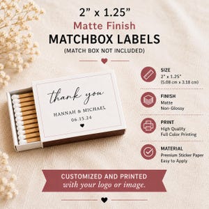 May include: A rectangular matchbox with a white label featuring the text thank you, HANNAH & MICHAEL, and 06.15.24. The label measures 2 inches by 1.25 inches and has a matte finish. The box contains wooden matches with white tips.