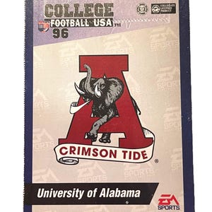 May include: A collectible trading card featuring the University of Alabama Crimson Tide. The card has a red 'A' with an elephant graphic, the words "CRIMSON TIDE" on a banner, and "University of Alabama" at the bottom. The card is from the "COLLEGE FOOTBALL USA 96" series.