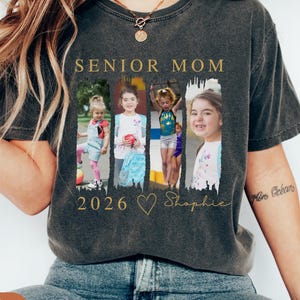 May include: Dark gray t-shirt with the words "SENIOR MOM" in gold lettering. The shirt features four framed photos of a child, the year "2026", a heart, and the name "Shophie" in gold script.