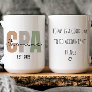 May include: Two white ceramic mugs with black handles and rims. One mug features "CPA Jasmine EST. 2026" in brown and green. The other mug says "TODAY IS A GOOD DAY TO DO ACCOUNTANT THINGS" with a heart.
