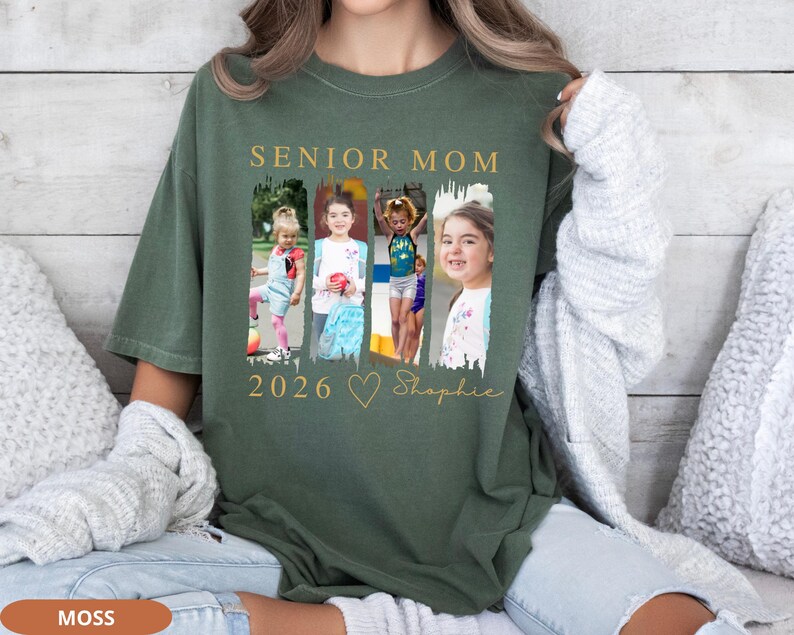 May include: A moss green t-shirt with the words "SENIOR MOM 2026" in gold lettering. The shirt features a collage of four photos of children. Below the photos is a gold heart and the name "Shopie" in script.