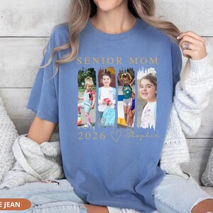 May include: Blue jean colored t-shirt with the words "SENIOR MOM" in gold lettering above a collage of four photos. Below the photos are the numbers "2026", a heart, and the name "Sophie" in gold script.