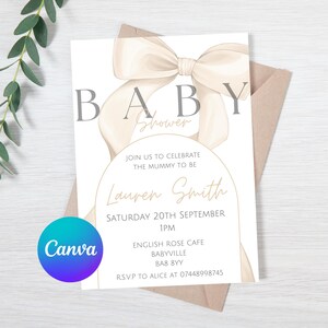 May include: A white baby shower invitation with a large beige bow and the text "BABY Shower" at the top. The invitation includes the text "Join us to celebrate the mummy to be Lauren Smith Saturday 20th September 1PM English Rose Cafe Babyville BA8 8YY RSVP to Alice at 07448998745".