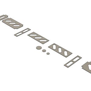 May include: A collection of gray, geometric metal pieces, including rectangular shapes with oval cutouts and small circular components. The arrangement suggests components for a larger structure or design, possibly for crafting or engineering projects.