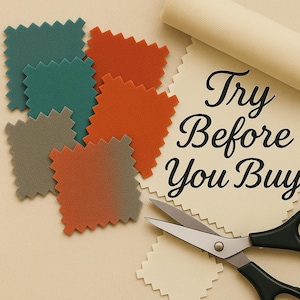 Op de afbeelding: Een verzameling kleurrijke stofstalen in tinten van teal, oranje en grijs, met een crèmekleurige rol stof en een schaar. De tekst "Try Before You Buy" staat op een crèmekleurig stofstaal.