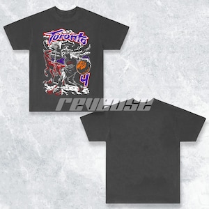 May include: Black t-shirt featuring a vintage-style graphic of a basketball player dribbling a ball with the word "Toronto" above him.