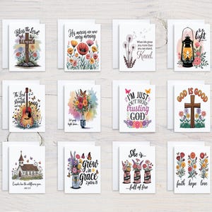 May include: A collection of greeting cards with various watercolor designs and inspirational quotes. The cards feature images of crosses, flowers, a guitar, and a church. Each card is on a white background.