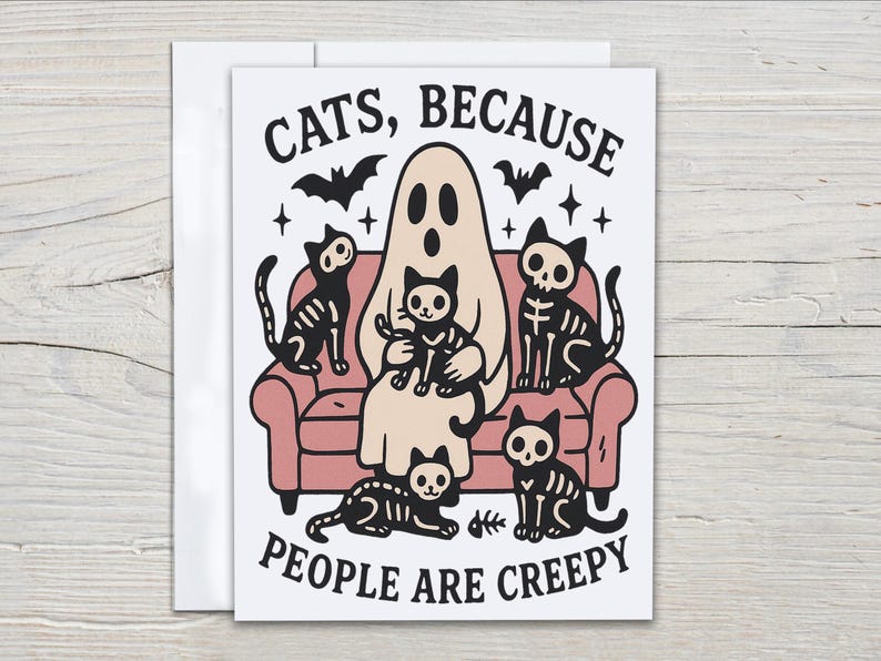 May include: A Halloween-themed greeting card featuring a ghost and skeleton cats on a pink couch. The text reads "CATS, BECAUSE PEOPLE ARE CREEPY" with bats and stars. The illustration is in black, white, and beige.