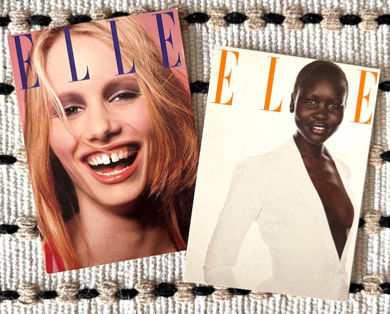 May include: Two vintage ELLE magazine covers. One features a smiling blonde woman with the magazine title in large blue letters. The other cover shows a woman in a white blazer with the magazine title in orange letters.