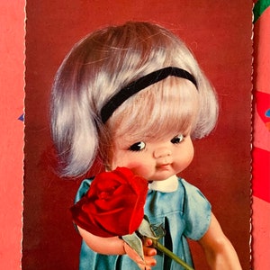 Ongebruikte jaren '70 Vintage Doll Ansichtkaart Schattig Meisje Blauwe Jurk Rode Roos no4