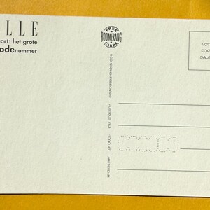 May include: A cream-colored postcard with the word "ELLE" at the top, followed by text in Dutch. The postcard has a "Boomerang Cards" logo and the words "NOT FOR SALE" in a box. Horizontal lines are at the bottom.