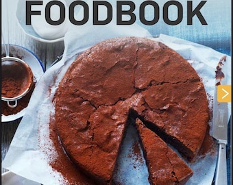May include: A cookbook titled "Dessert Lovers FOODBOOK" with a photo of a chocolate cake dusted with cocoa powder. The book features recipes for slices and biscuits, cakes and puddings, including brownies, donuts, and lemon tarts.