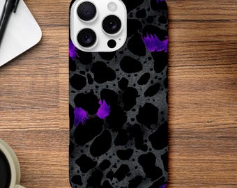 May include: A smartphone case with a black and gray spotted pattern, accented with purple brushstrokes. The case has a glossy finish and a camera cutout.