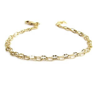 May include: A gold chain bracelet with a delicate, oval-shaped link design.