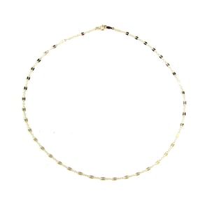 May include: Delicate gold-colored necklace with a repeating oval link design. The necklace is displayed on a white background. The chain is thin and the clasp is visible. This necklace is a piece of jewelry.